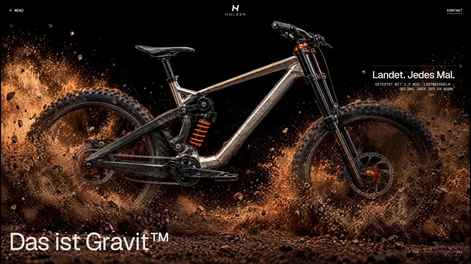 Startseite von holzer-bikes.com: das Downhillbike landet in einer Staubwolke, unten die Headline „Das ist Gravit™“